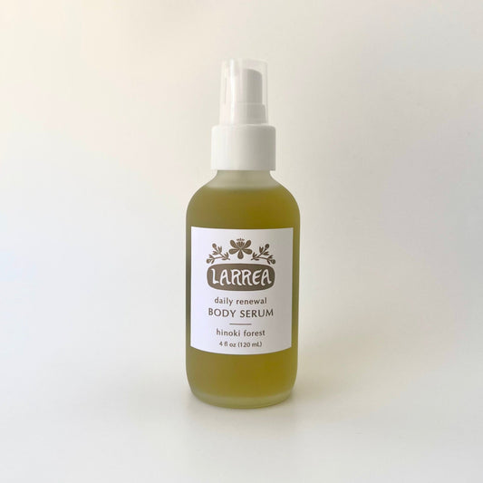 Bottle of Larrea Hinoki Forest Body Serum on a white background